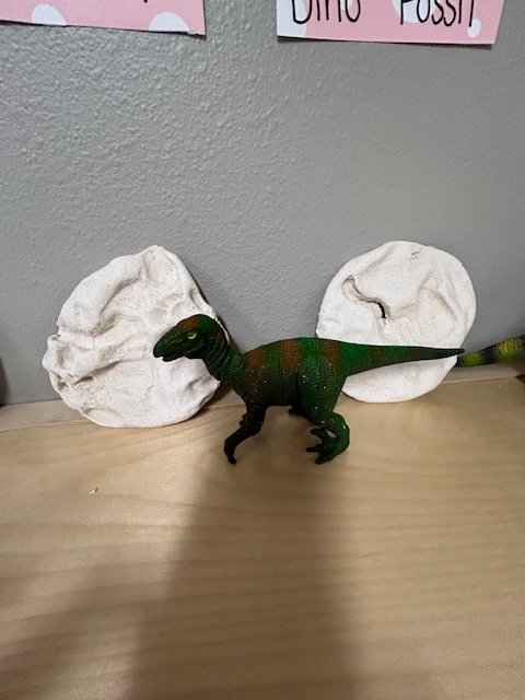 Photo of a painted dinosaur and white clay art